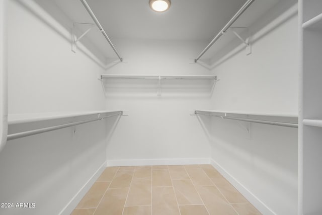 spacious closet with tile patterned flooring