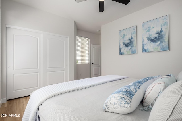 bedroom featuring ceiling fan, a closet, and light hardwood / wood-style floors