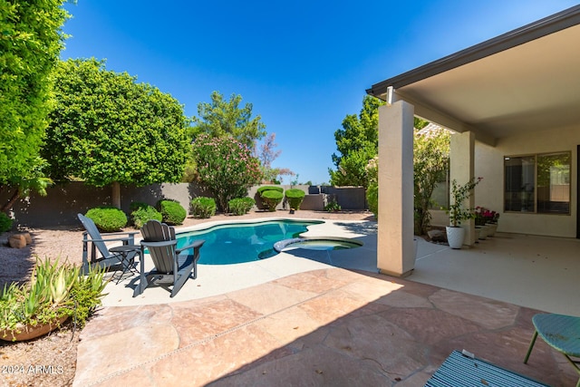 view of pool featuring an in ground hot tub and a patio area