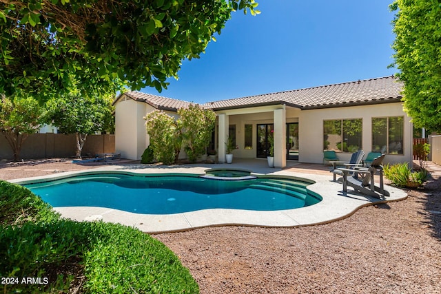 view of swimming pool featuring a patio area and an in ground hot tub