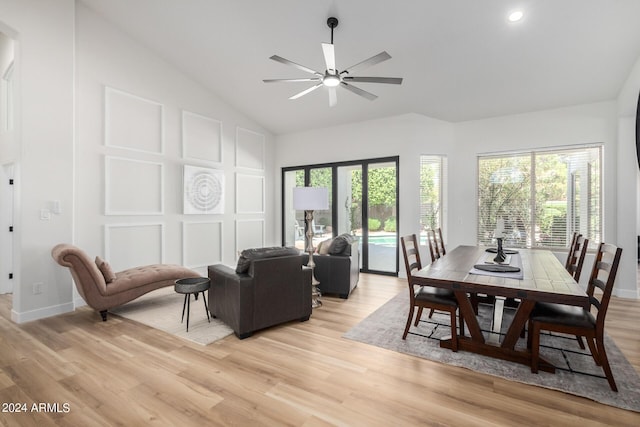 dining space featuring a healthy amount of sunlight, high vaulted ceiling, ceiling fan, and light wood-type flooring