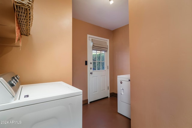 clothes washing area with washing machine and dryer