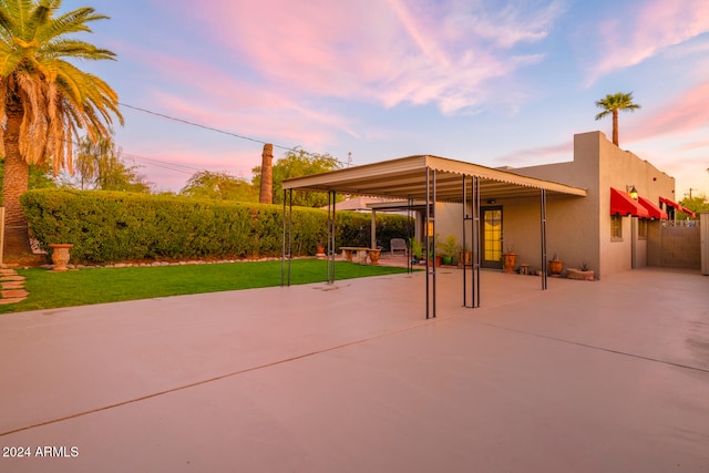 view of community with a patio and a lawn