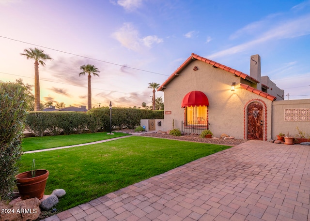 mediterranean / spanish-style home featuring a lawn