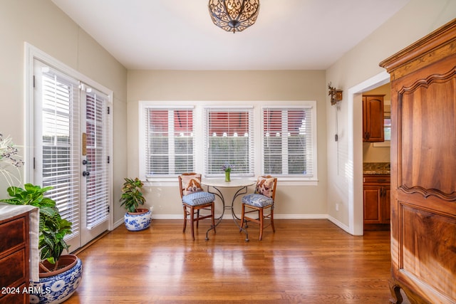 sitting room with a wealth of natural light and hardwood / wood-style floors