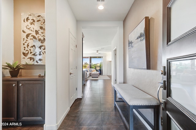 hall with dark tile patterned floors