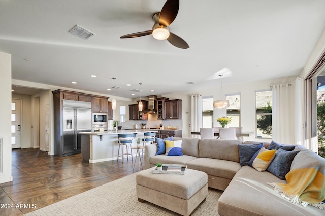 living room featuring ceiling fan and sink