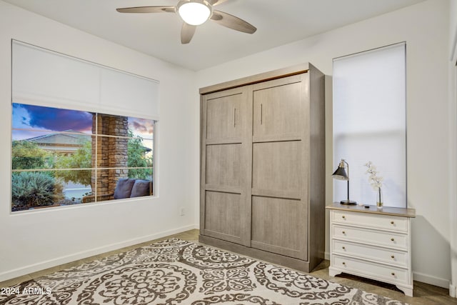 bedroom featuring ceiling fan and a closet