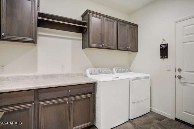 clothes washing area featuring dark tile patterned flooring, cabinets, and separate washer and dryer