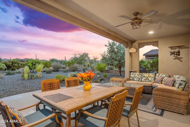 patio terrace at dusk with an outdoor hangout area and ceiling fan