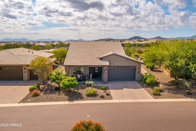 view of front of home with a mountain view and a garage