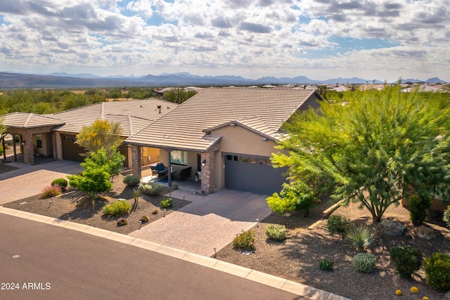 view of front facade with a mountain view and a garage