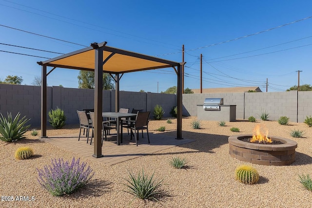 2227 W Cambridge Ave, Phoenix, AZ 85009 - view of yard featuring area for grilling, a fire pit, a fenced backyard, and a patio area