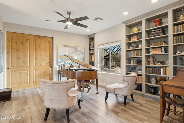 sitting room featuring ceiling fan and light hardwood / wood-style flooring