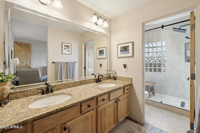 bathroom with tile patterned flooring, vanity, toilet, and a shower with shower door