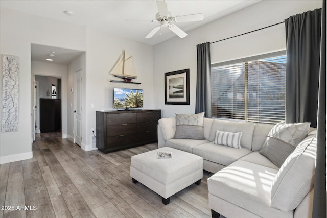 living room featuring ceiling fan and light hardwood / wood-style floors