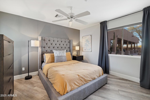 bedroom with ceiling fan and light hardwood / wood-style flooring