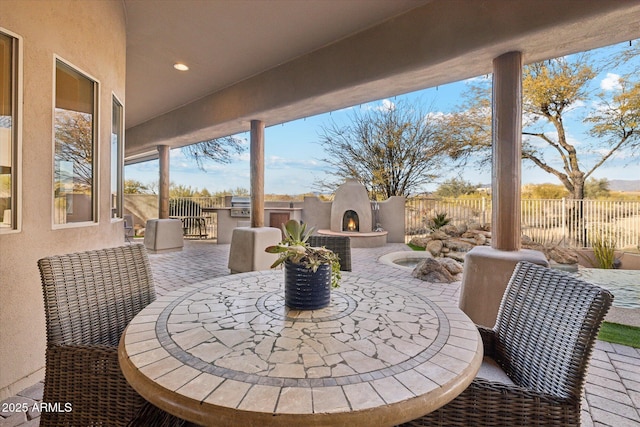 view of patio / terrace featuring area for grilling and an outdoor fireplace