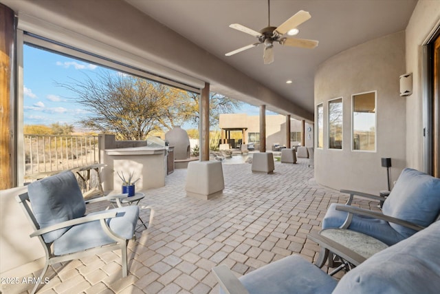 view of patio with area for grilling, an outdoor living space, and ceiling fan