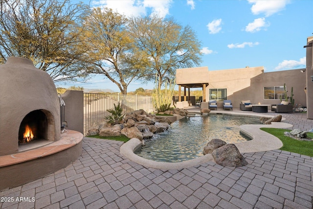 view of patio / terrace featuring an outdoor living space with a fireplace