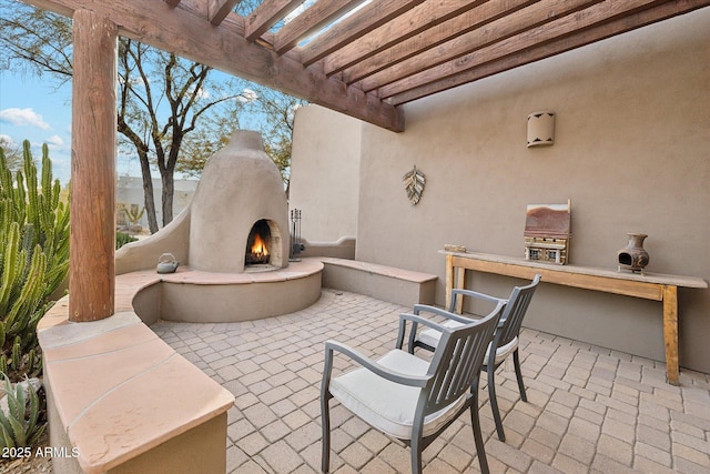 view of patio / terrace with an outdoor fireplace, area for grilling, and a pergola