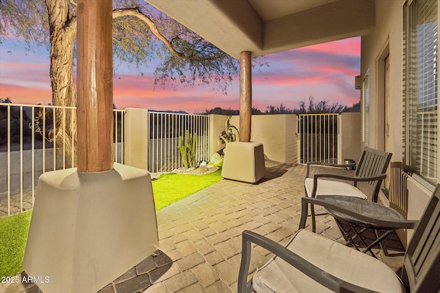 patio terrace at dusk with a balcony