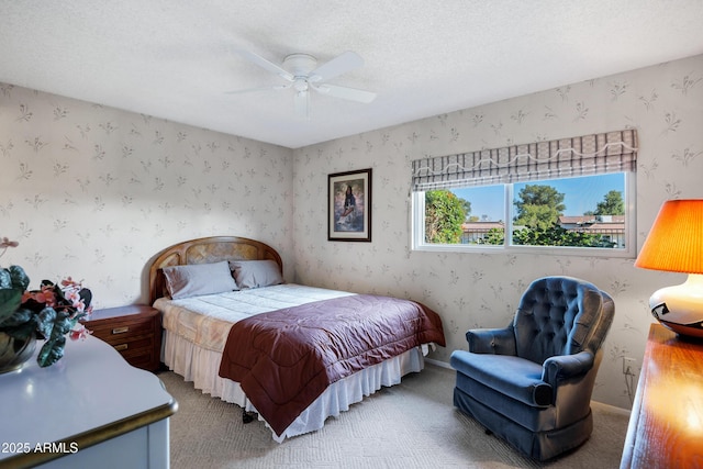 bedroom with ceiling fan, carpet, and a textured ceiling