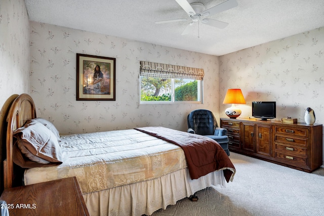 bedroom featuring ceiling fan, a textured ceiling, and carpet flooring