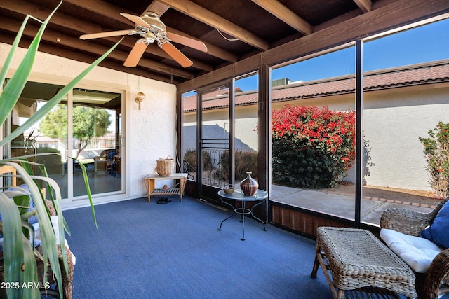 sunroom / solarium featuring ceiling fan