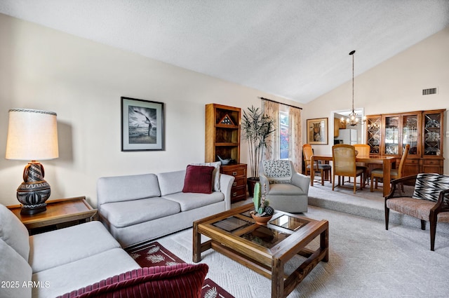 carpeted living room featuring vaulted ceiling, a notable chandelier, and a textured ceiling