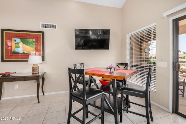 tiled dining room featuring baseboards and visible vents