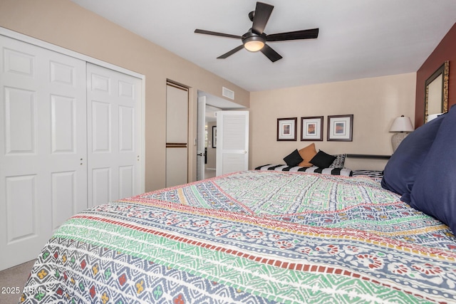 bedroom with ceiling fan, carpet, a closet, and visible vents