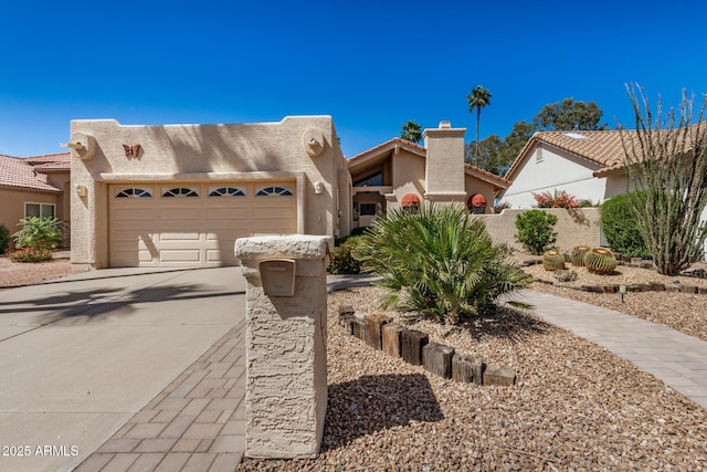 view of front of house featuring a garage, stucco siding, a chimney, concrete driveway, and a tile roof