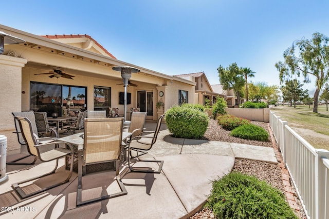 view of patio with a fenced backyard, outdoor dining area, and ceiling fan