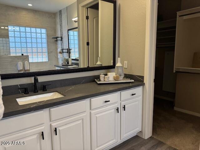 bathroom featuring vanity, hardwood / wood-style floors, and a shower