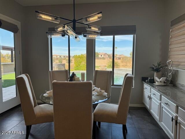 dining space featuring dark tile patterned floors