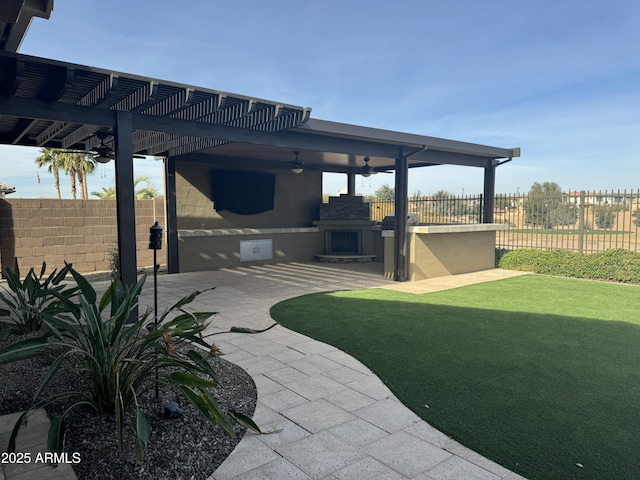 view of patio / terrace with a pergola, a fireplace, and ceiling fan