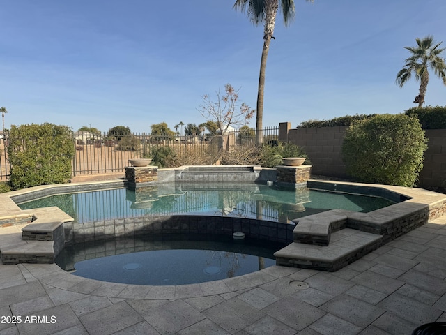 view of swimming pool featuring an in ground hot tub