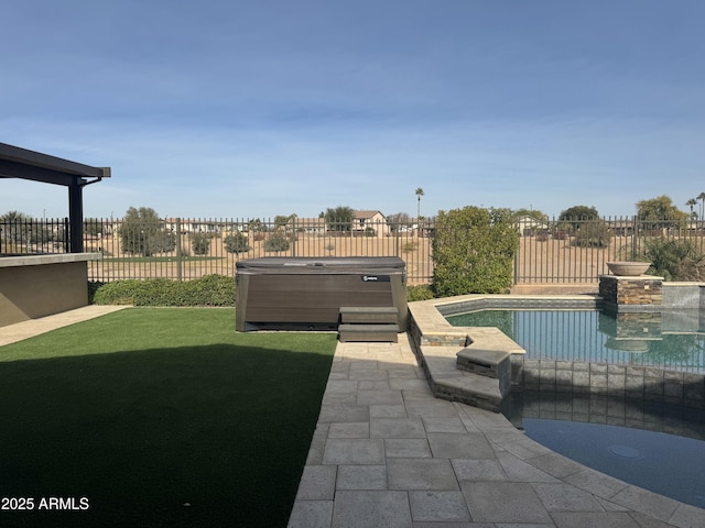 view of pool with a yard, a hot tub, and a patio area