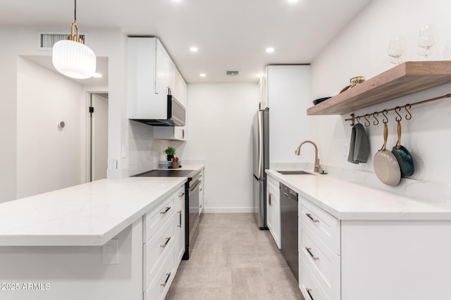 kitchen featuring sink, appliances with stainless steel finishes, white cabinetry, light stone counters, and decorative light fixtures