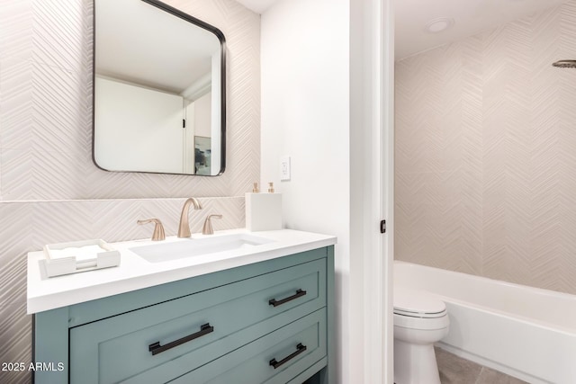 full bathroom featuring tile patterned flooring, tile walls, vanity, tasteful backsplash, and toilet