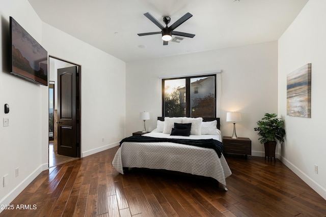 bedroom with hardwood / wood-style flooring, visible vents, baseboards, and a ceiling fan