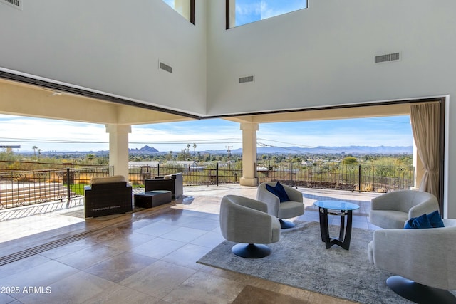 view of patio / terrace featuring a fenced backyard, a mountain view, visible vents, and an outdoor living space