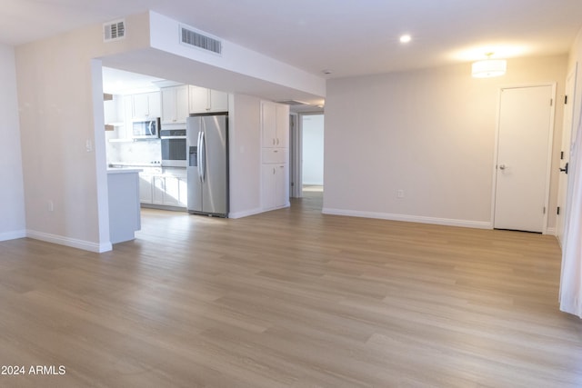 unfurnished living room with light hardwood / wood-style flooring