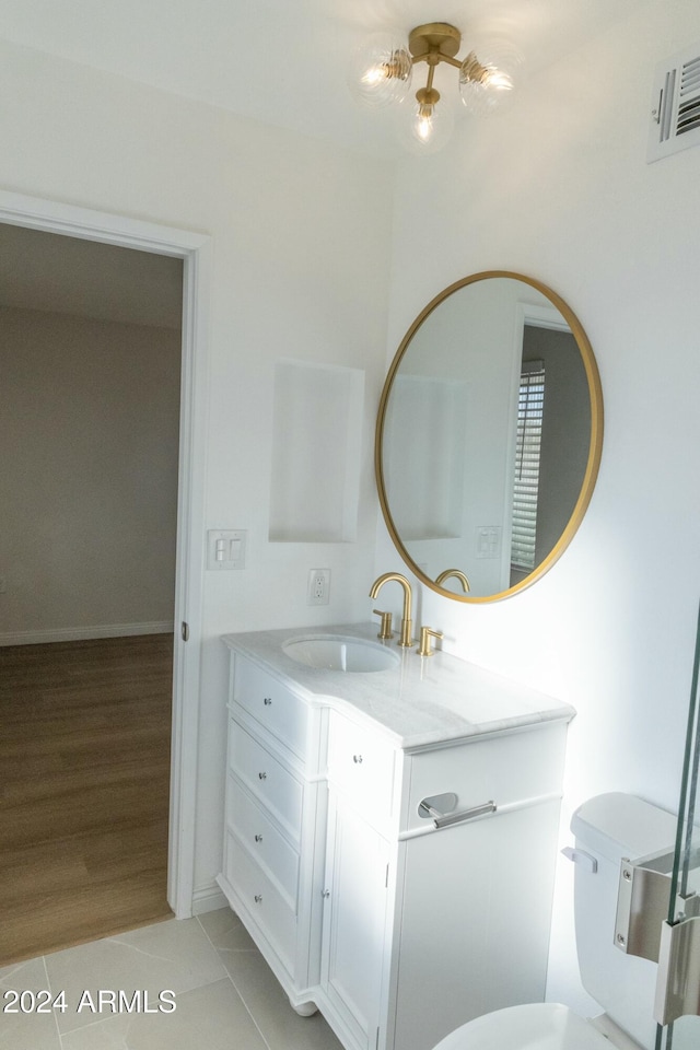 bathroom with vanity, hardwood / wood-style flooring, and toilet