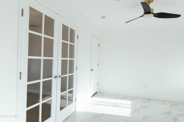 spare room featuring ceiling fan and french doors