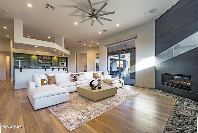 815 E County Down Dr, Chandler, AZ 85249 - living area with light wood-type flooring, a tile fireplace, visible vents, and recessed lighting