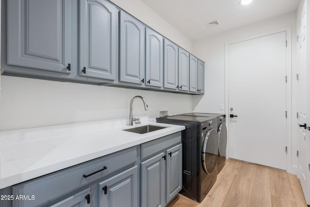815 E County Down Dr, Chandler, AZ 85249 - clothes washing area featuring cabinet space, visible vents, light wood-style flooring, separate washer and dryer, and a sink