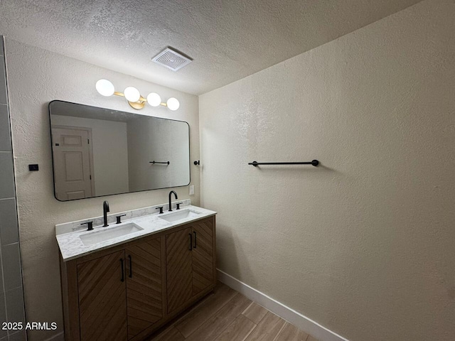 bathroom with vanity and a textured ceiling