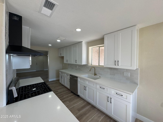 kitchen featuring sink, white cabinetry, dark hardwood / wood-style floors, stainless steel appliances, and wall chimney range hood